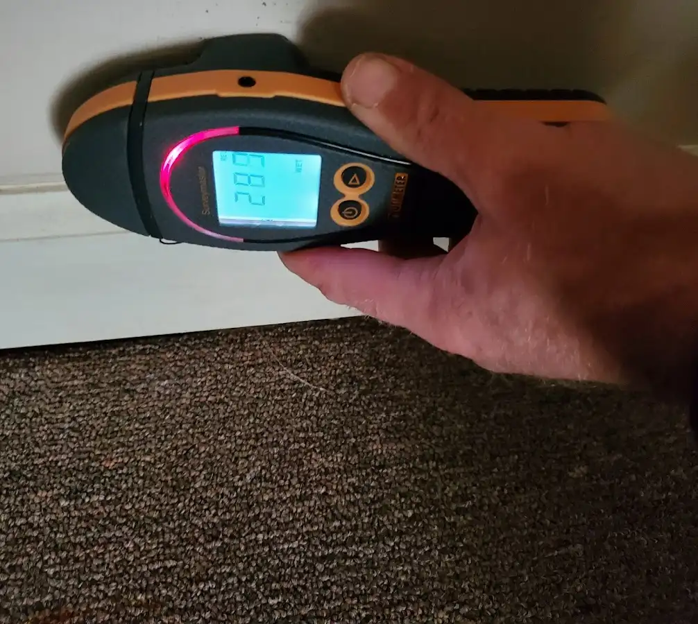 Moisture detection at baseboard during Storm Damage Restoration in Stillwater